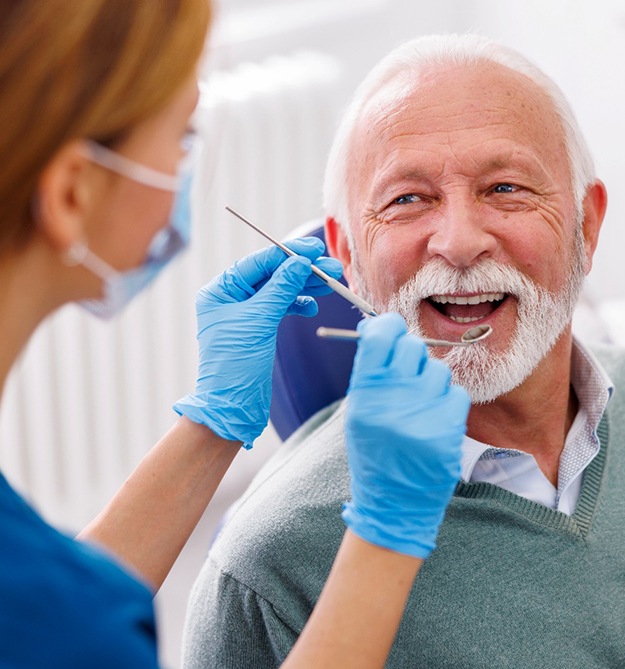 Man smiles at dentist