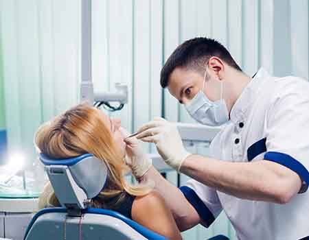 Dentist looking in woman’s mouth