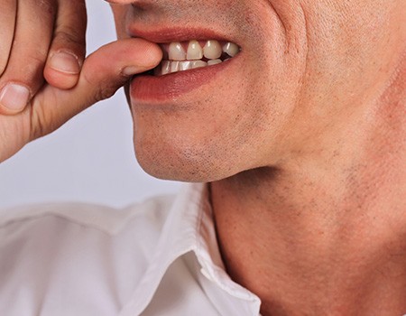 Closeup of person biting their nails