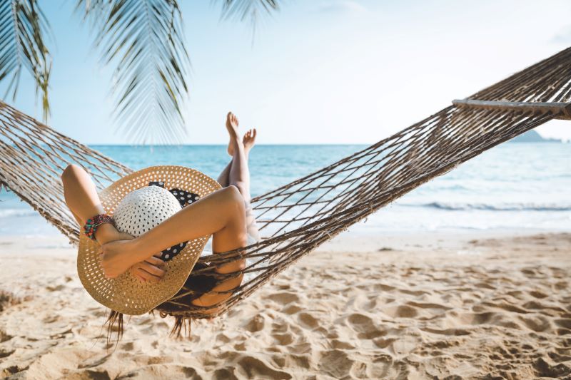 person on summer vacation smiling on a beach